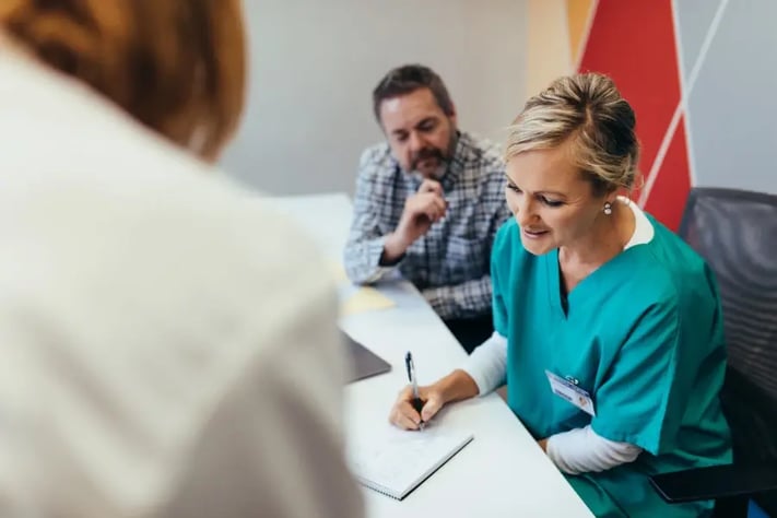 Female behavior therapist discussing notes with colleagues