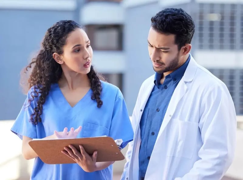 Healthcare professional outside discussing patient updates