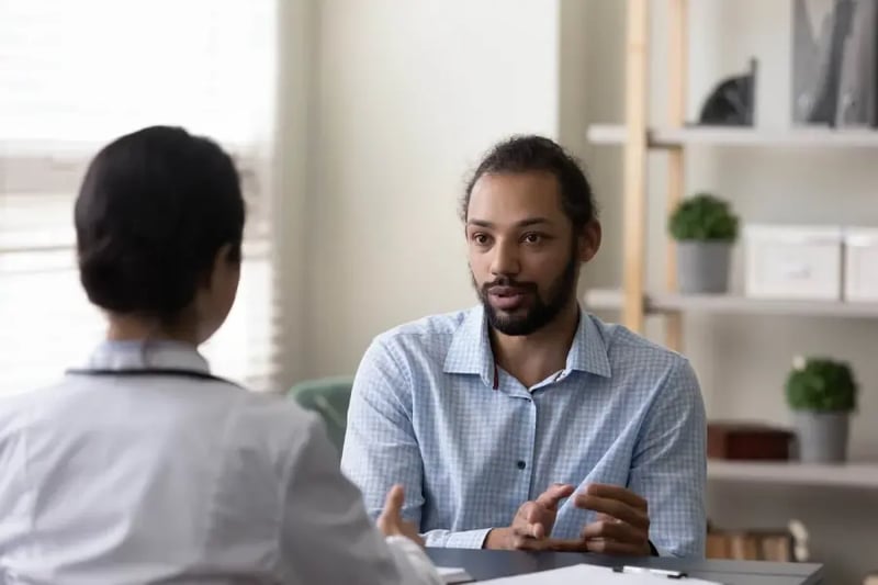 Female BCBA-D discussing behavior notes with adult client