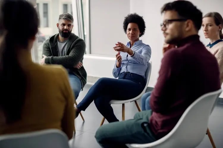 Adults discussing behavior challenges in a group setting