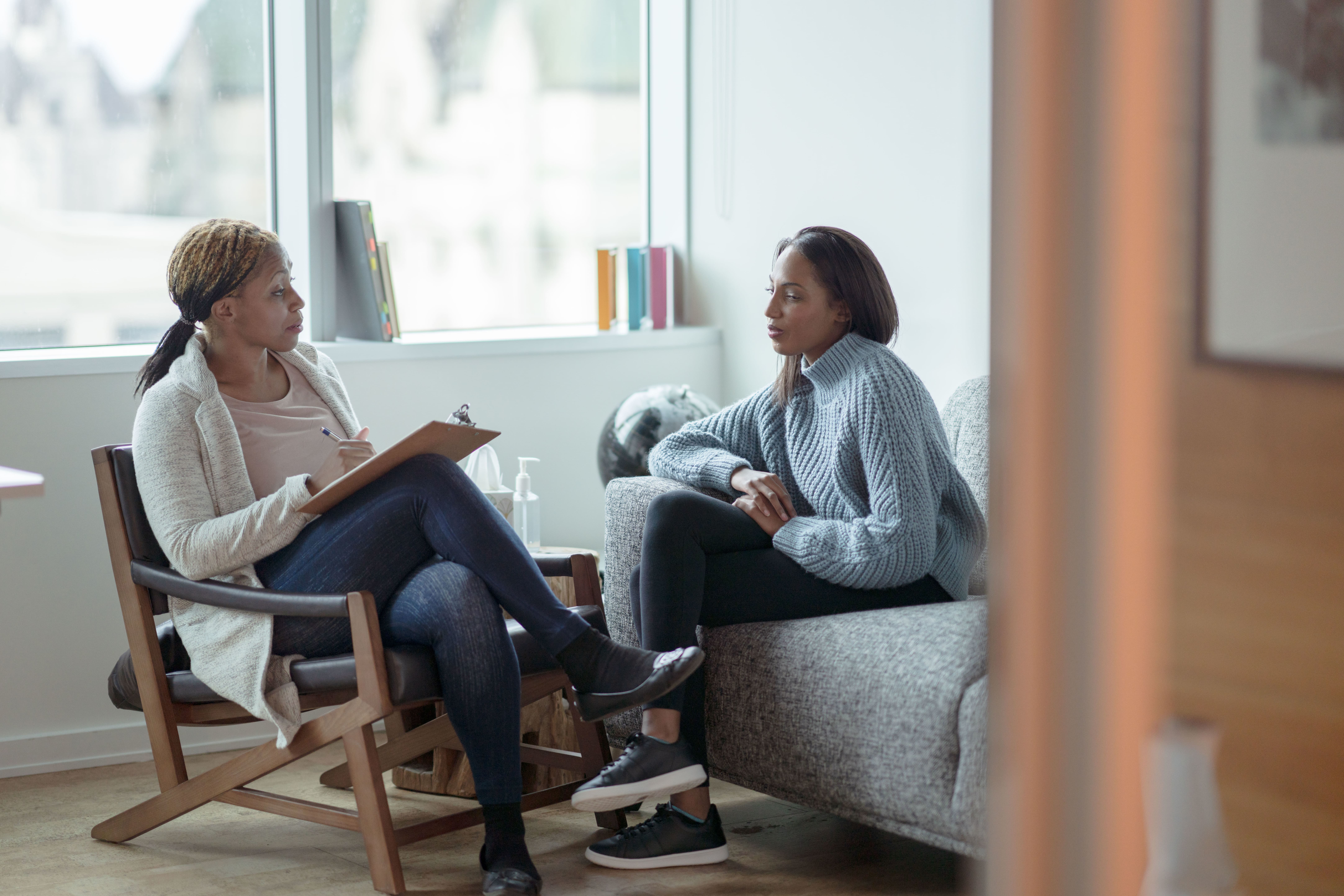 female behavior therapist conducting a session with a female student