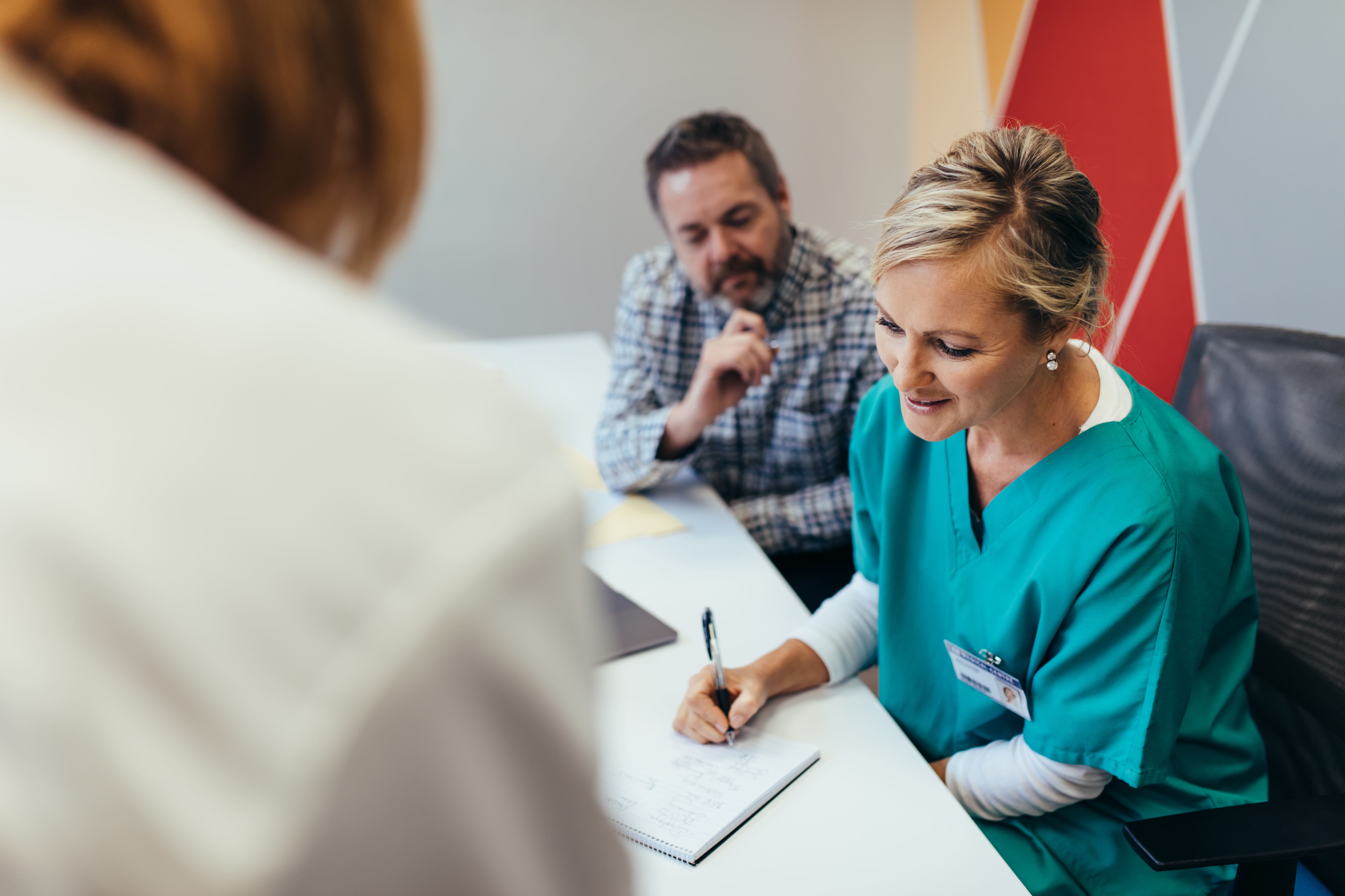 female behavior therapist discussing notes with colleagues