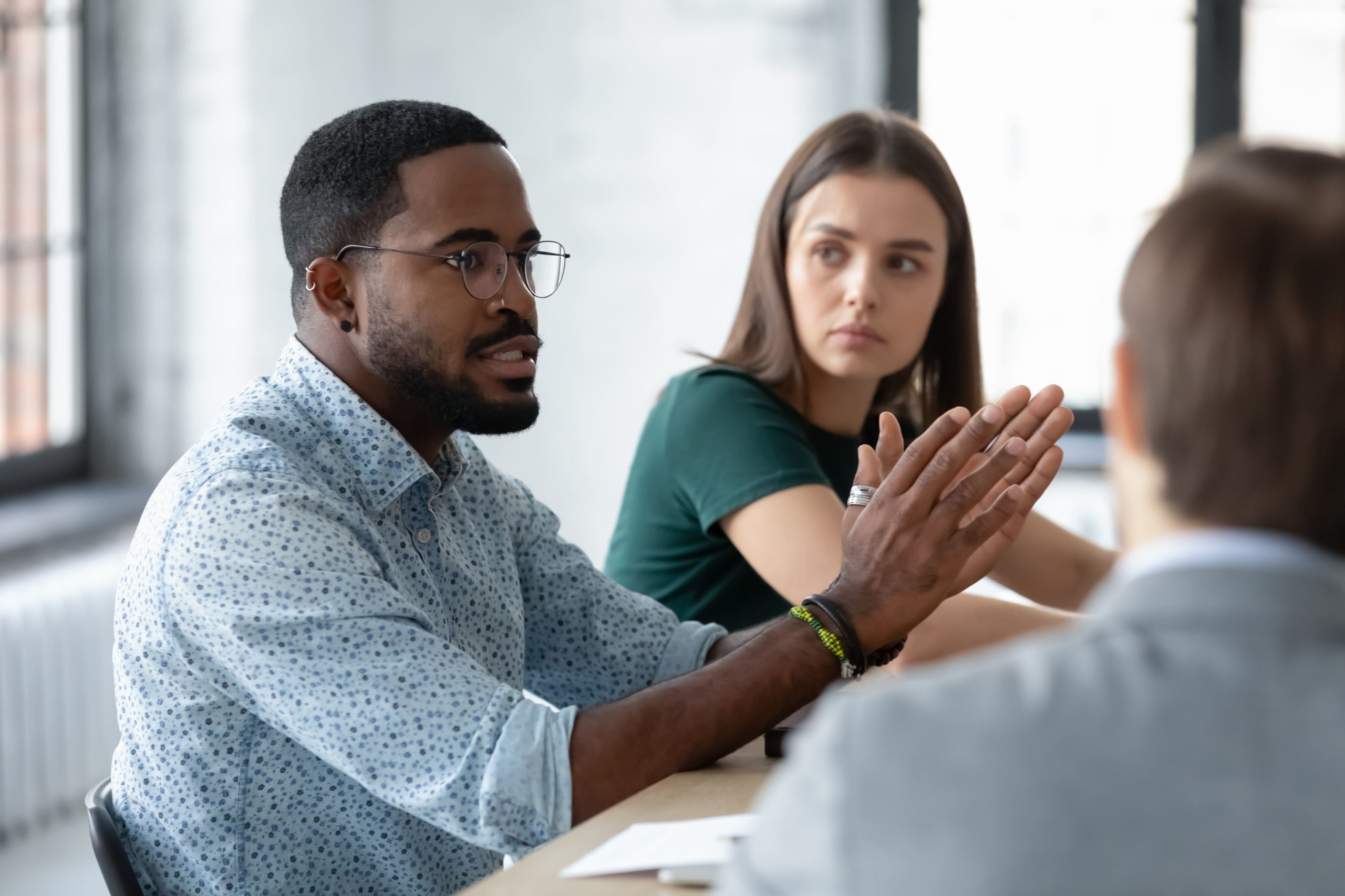 Male professional having a conversation with his colleagues