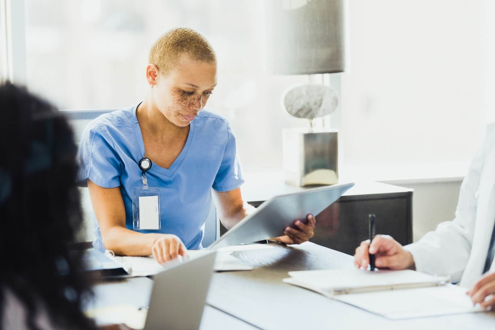 female therapist reading patient chart